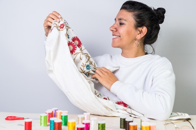 Happy student showing embroidered cloth